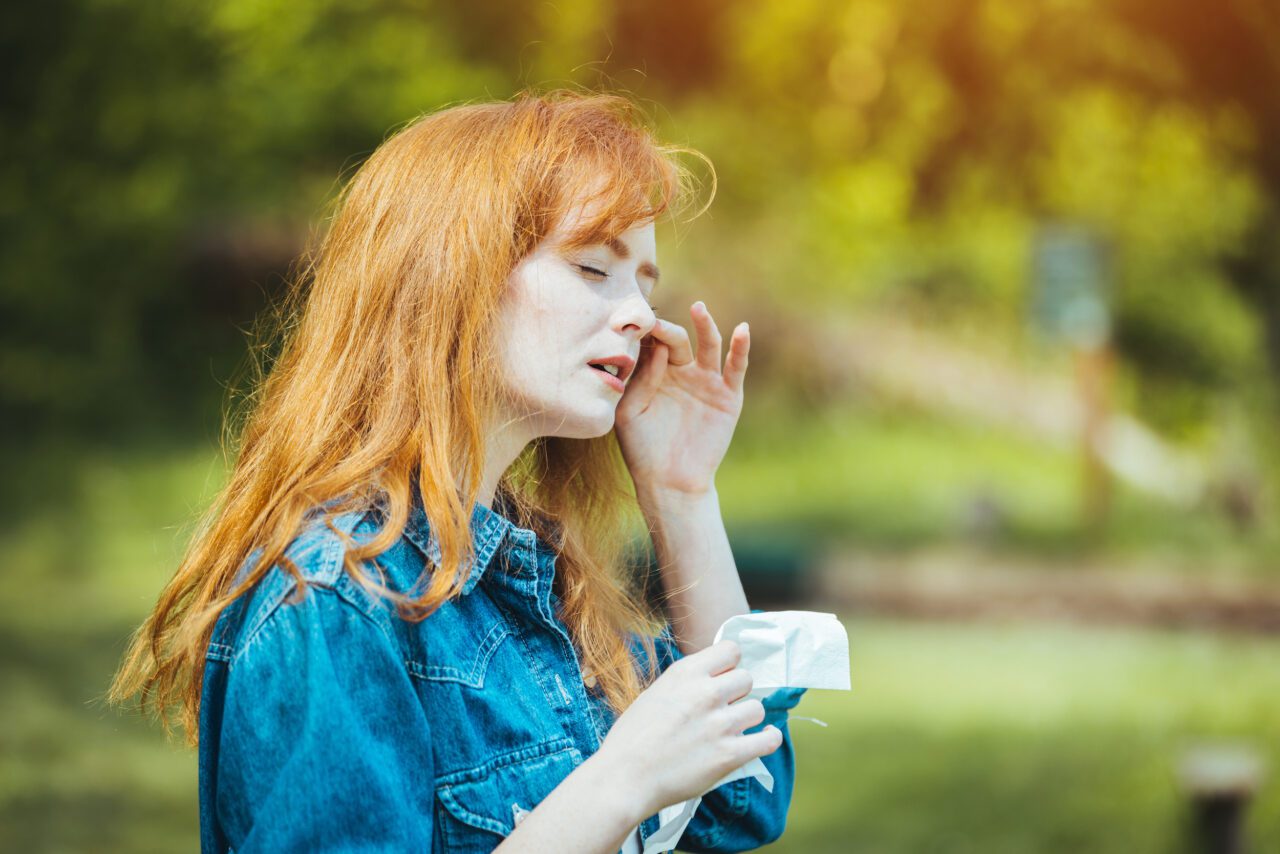 Woman rubbing her eye outdoors. Chronic Disease Control, Allergy Induced Asthma Remedy And Chronic Pulmonary Disease Concept. Attractive Woman Outdoors is Having Allergy